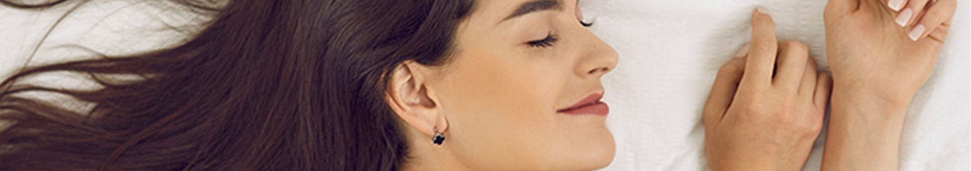 Woman smiling while sleeping on her side